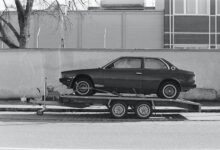 a car is being towed on a flatbed trailer